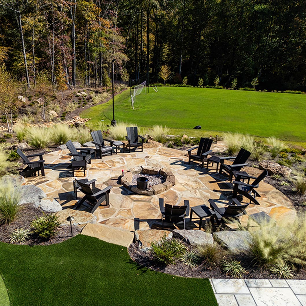A beautiful landscaping project with a pool, putting green, and soccer field, built by R&R Landscaping