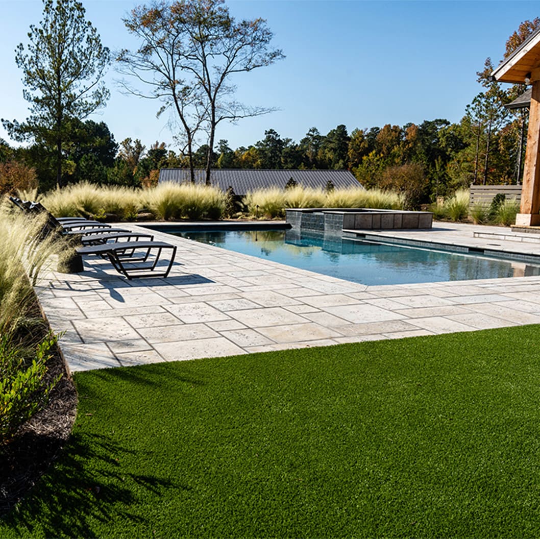A beautiful landscaping project with a pool, putting green, and soccer field, built by R&R Landscaping