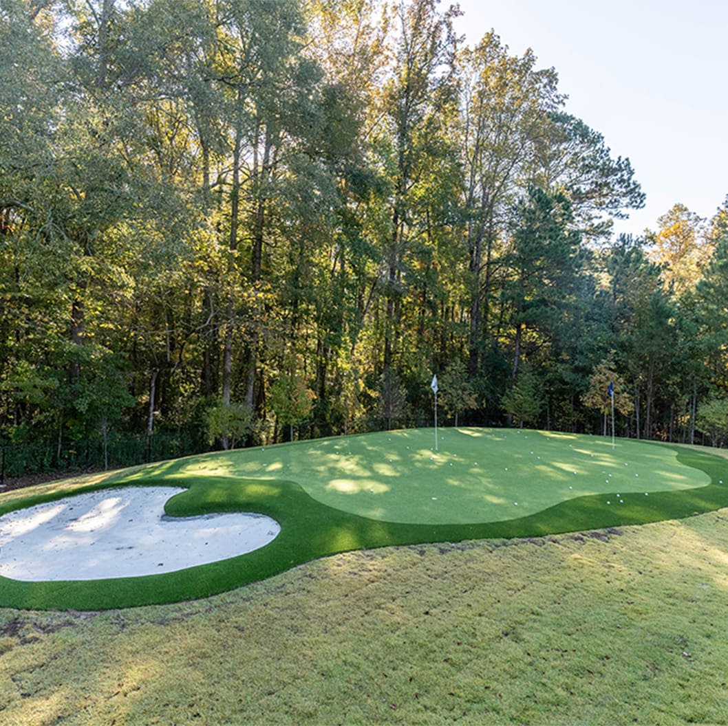 A beautiful landscaping project with a pool, putting green, and soccer field, built by R&R Landscaping