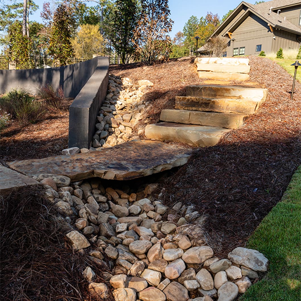 A beautiful landscaping project with a pool, putting green, and soccer field, built by R&R Landscaping