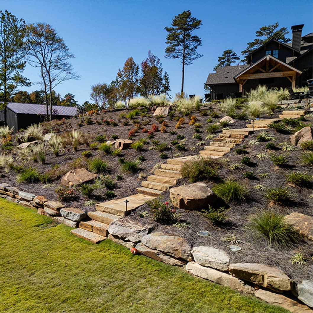 A beautiful landscaping project with a pool, putting green, and soccer field, built by R&R Landscaping