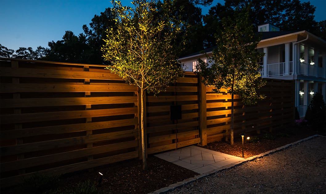A beautiful outdoor landscaping project with firepit and lighting designed and built by R&R Landscaping.