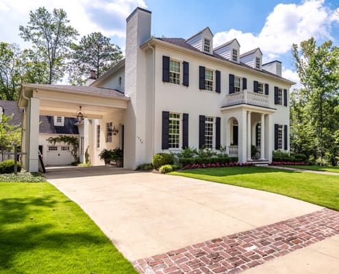 A resort-style backyard with beautiful plants, a swimming pool, fire pit, and putting green. This landscape was designed and built by R&R Landscaping.