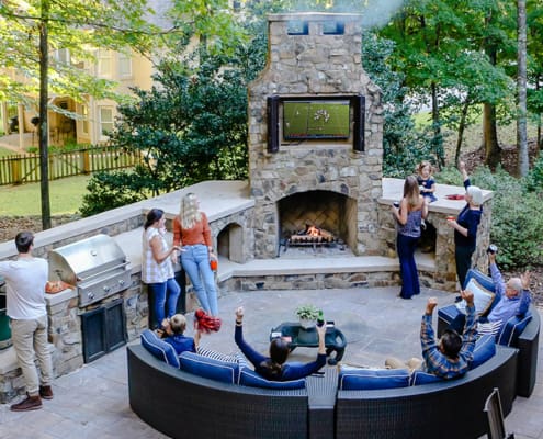 A beautiful outdoor kitchen and sitting area perfect for tailgating at home. This project was designed and built by R&R Landscaping
