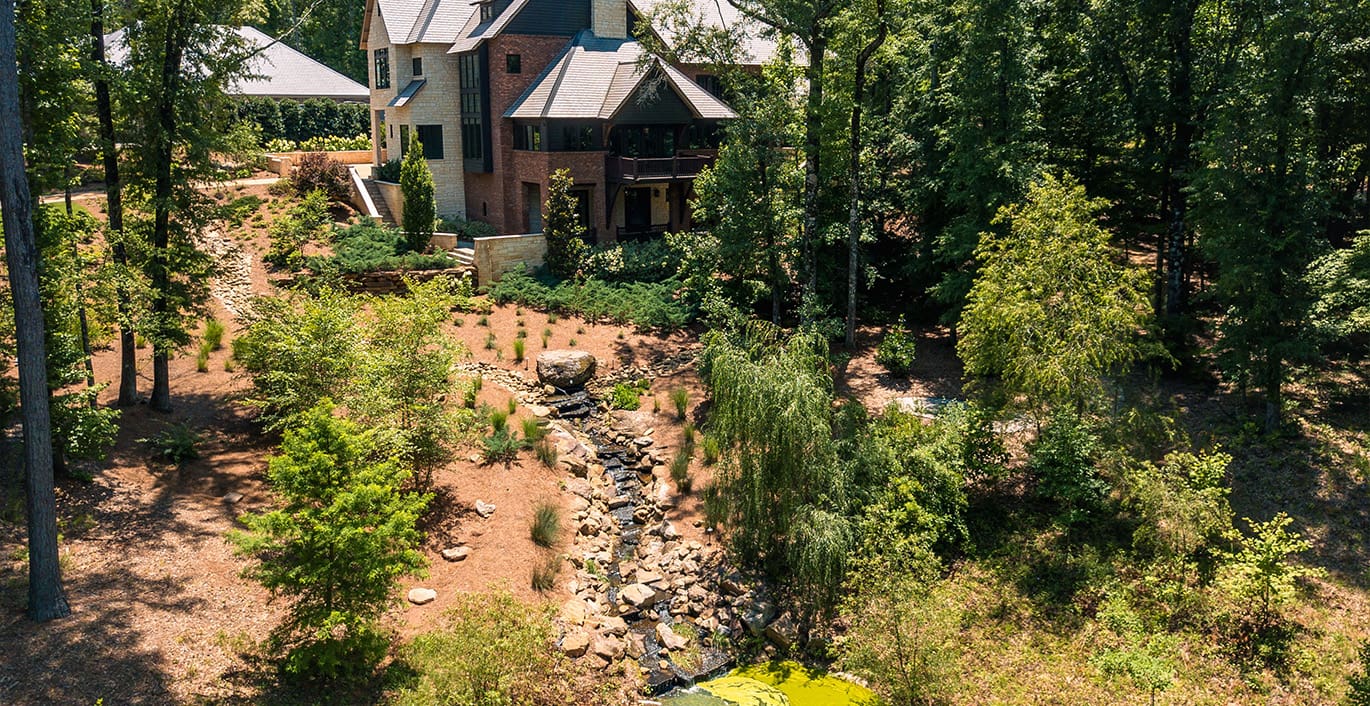 R&R Landscaping A beautiful sloped backyard transformation and pond installation, complete with natural rock creek. This project was designed and installed by R&R Landscaping.